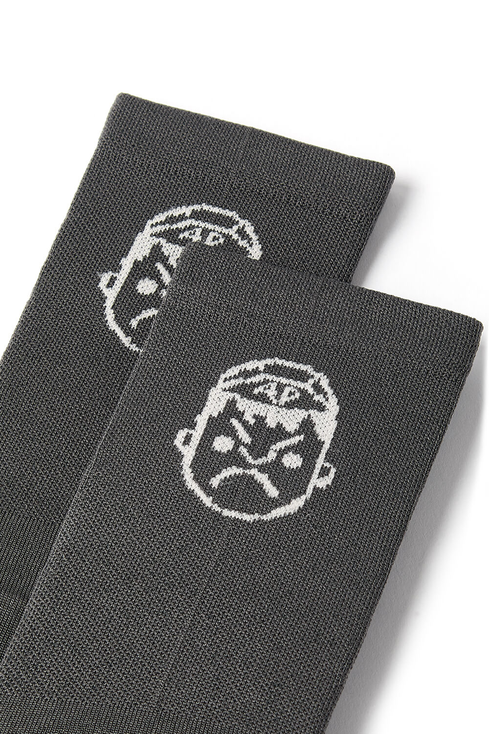 A detailed photo of the face logo on the Angry Pablo grey cycling socks
