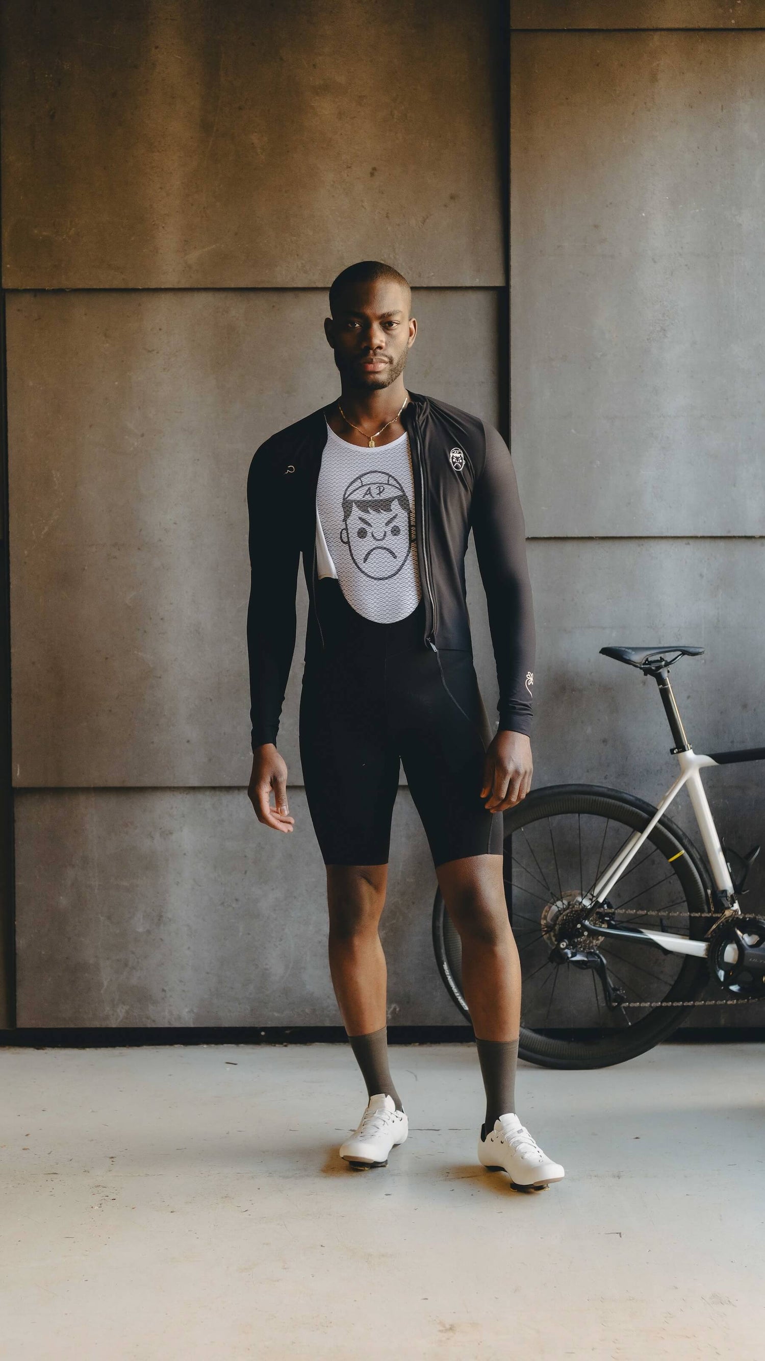 A man wearing Angry Pablo cycling kit and headphones