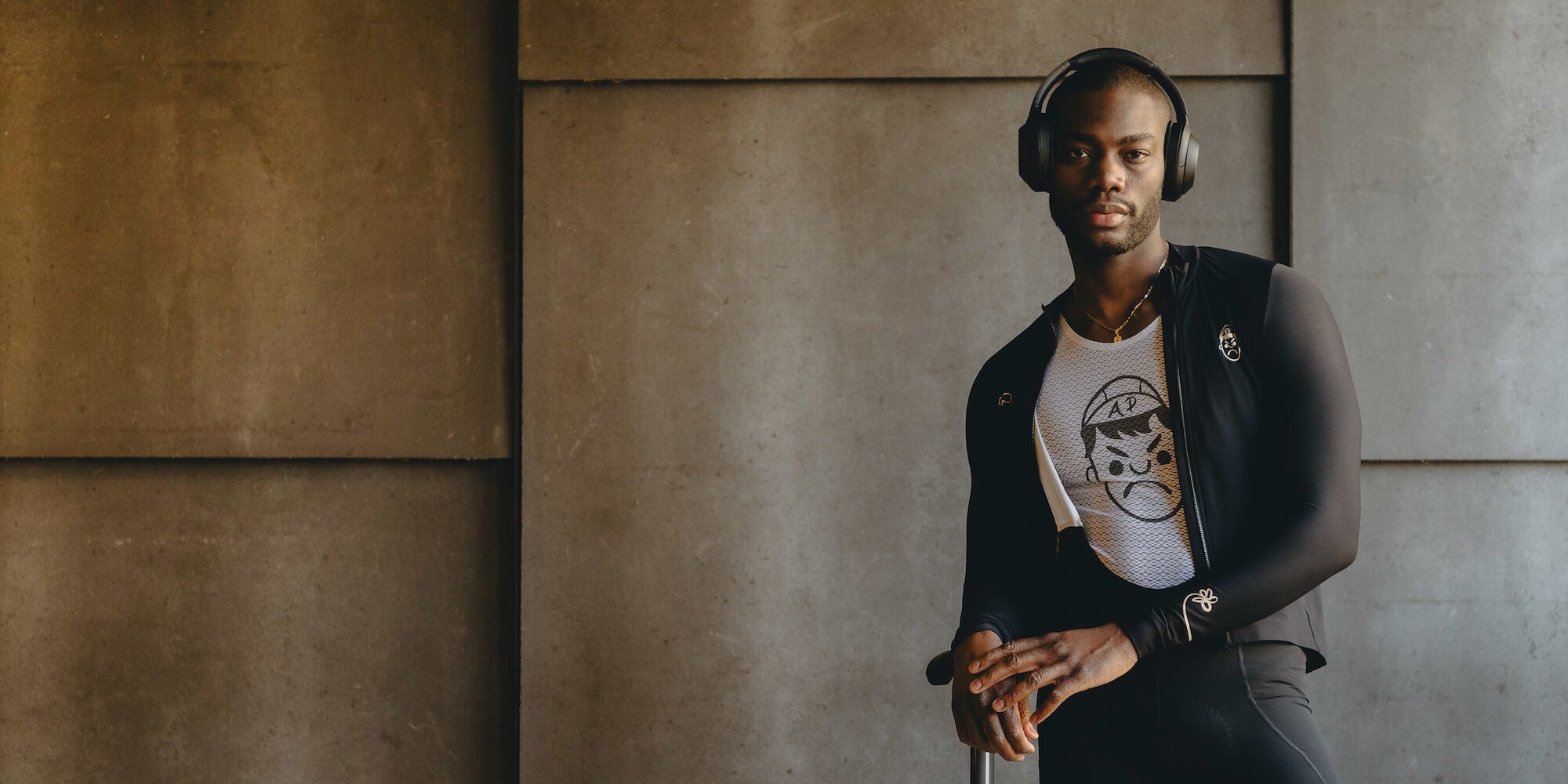 A man wearing Angry Pablo cycling kit and headphones