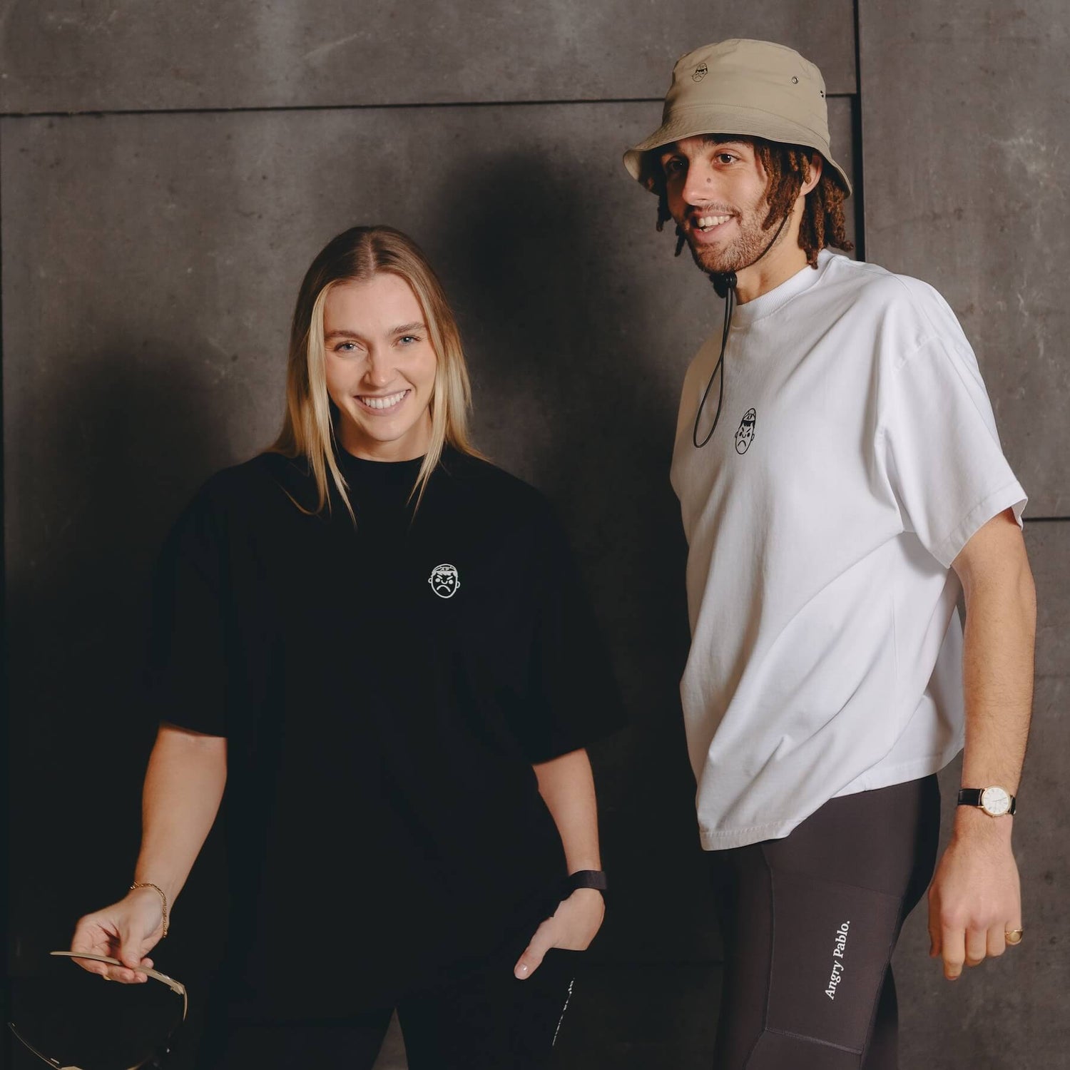 A male and female model wearing Angry Pablo heavyweight oversize white and black t-shirts