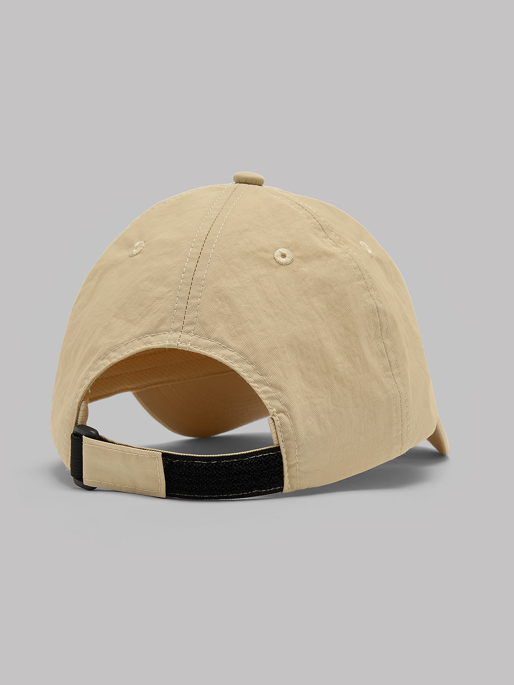 Beige cap with black band on a gray background