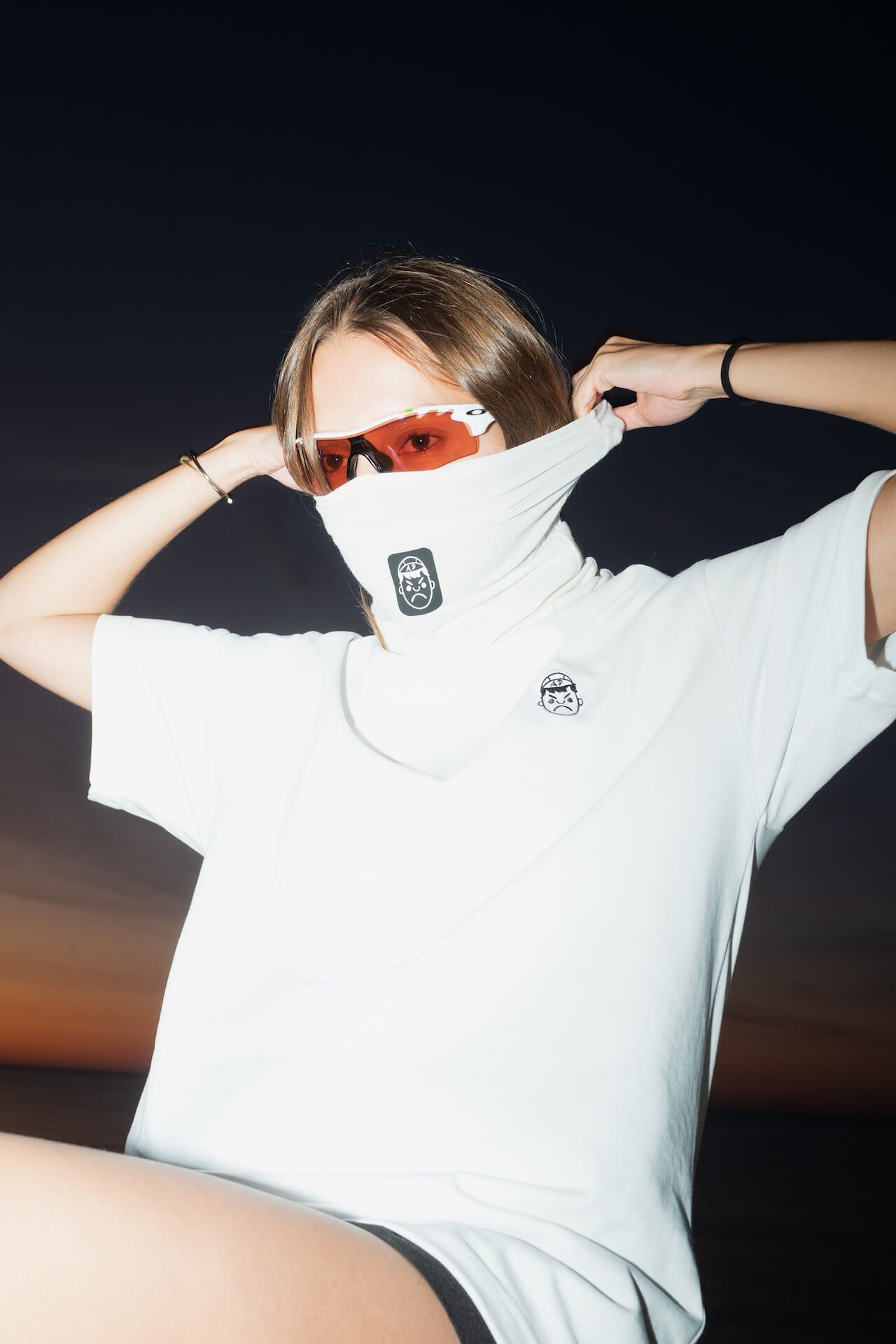 female runner stretching an angry pablo neck warmer